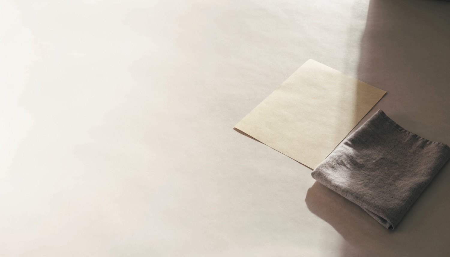 A blank sheet of paper beside a folded fabric swatch