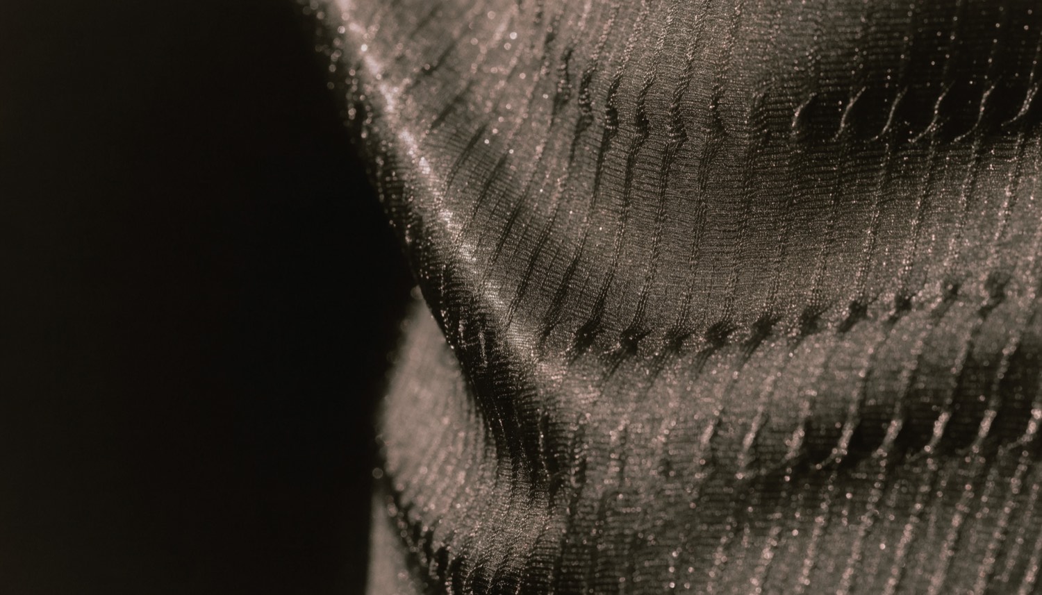 Dark technical synthetic knit, magnified